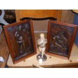 A pair of bronzed plaques, together with figurine