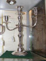 A silver three branch candelabra - 38cms high