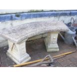 A stone garden bench on plinths - length 116cm