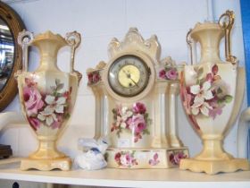 A ceramic floral patterned mantel clock, complete