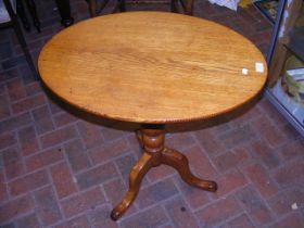 A 19th century oak oval snap top table