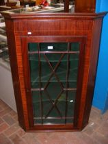 An antique mahogany hanging corner cupboard