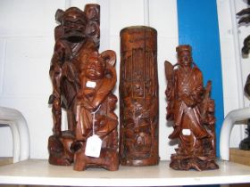 Carved oriental figures and a brush pot