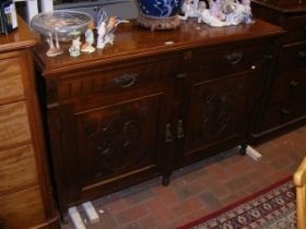 An Edwardian sideboard with drawers and cupboards