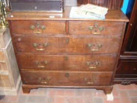 An antique oak country chest of two short and thre