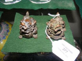 A pair of small Oriental bronze mythical beast pap