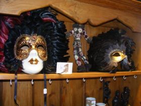 Two Venetian masks and a harlequin doll