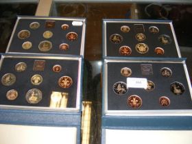 Four commemorative coin sets 1983, 1984, 1985, 198