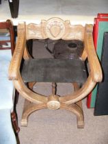 A carved oak X-frame chair