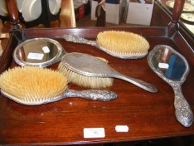 A silver back dressing table set
