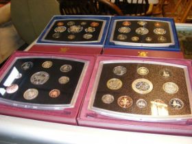 Four commemorative coin sets 2000, 2001, 2002, 200
