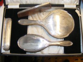 A silver backed dressing table set in presentation