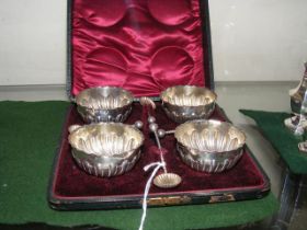 A cased set of four silver table salts and spoons
