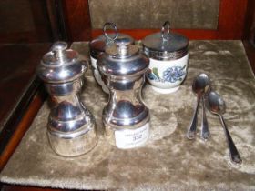 A pair of silver salt and pepper grinders, tea spo