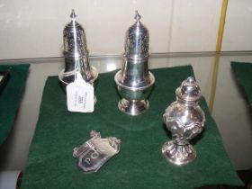 A pair of 12cm high silver pepperettes, together w