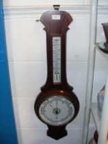 An aneroid barometer and thermometer in wooden cas