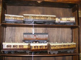 Six old 0 gauge tin plate coaches, together with 9