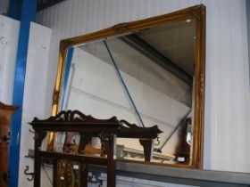 A large bevelled wall mirror in gilt frame