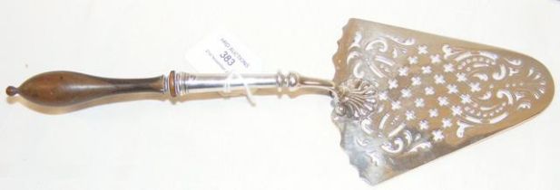 A George III silver fish slice with turned wooden