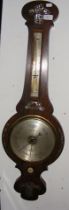 A wall barometer and thermometer