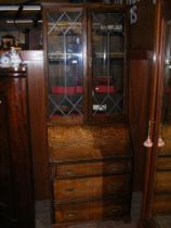 An antique oak bureau bookcase