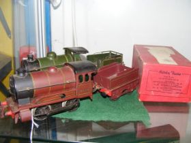 An old Hornby 0 gauge locomotive and tender with b