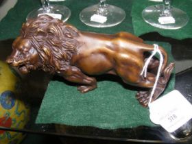 A 15cm long modern cast metal lion ornament