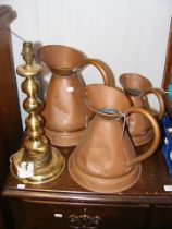 Three copper jugs, together with brass table lamp