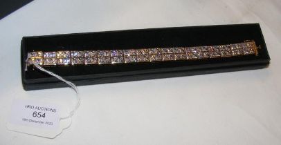 A gilt and silver cubic zirconium bracelet