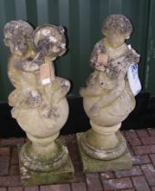 A pair of garden cherub statues