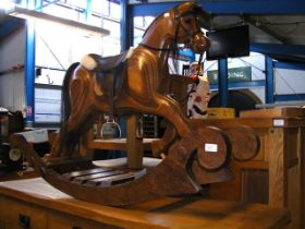 A Judy Fergusson design wooden rocking horse - length 115cm, height 73cm