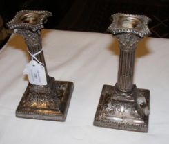 A pair of silver Corinthian column candlesticks -