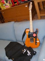 A Fender electric guitar, together with carrying c