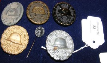 Five German badges, together with a German tie-pin