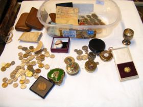 A container of various collectables including coins, mil