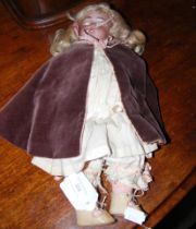 A Victorian bisque head doll with rolling eyes and