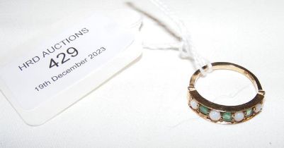 An emerald and opal ring in gold setting