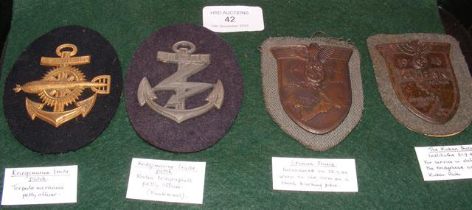 Four German uniform badges, including Kriegsmarine