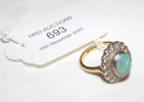 An opal and diamond ring in gold setting