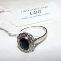 A diamond and sapphire ring in white gold setting