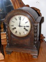 An oak cased striking mantel clock - 30cm high