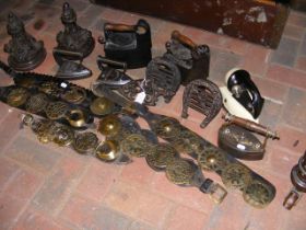 A medley of horse brasses and antique irons etc.