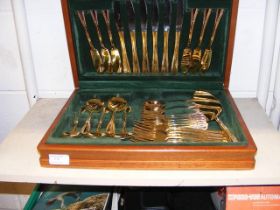 A gilt canteen of cutlery in case
