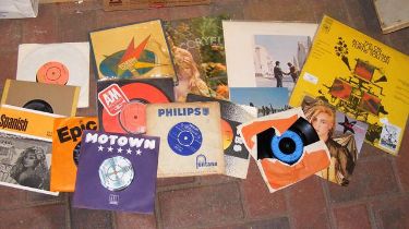 A small collection of vinyl records, including The