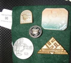 Four metal and one ceramic German lapel badges