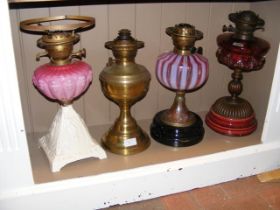Four Victorian oil lamps of varying design