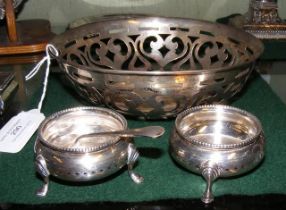 A pierced silver basket together with a pair of si