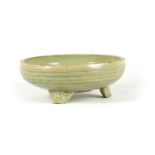 AN EARLY CELADON MING DYNASTY TRIPOD BULB BOWL