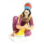 A COLOURFUL RUSSIAN SEATED YOUNG LADY FIGURE OF A WASHER GIRL