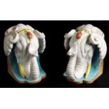 A STYLISH PAIR OF 19TH CENTURY FRENCH MAJOLICA BOOKENDS FORMED AS ELEPHANTS HEADS